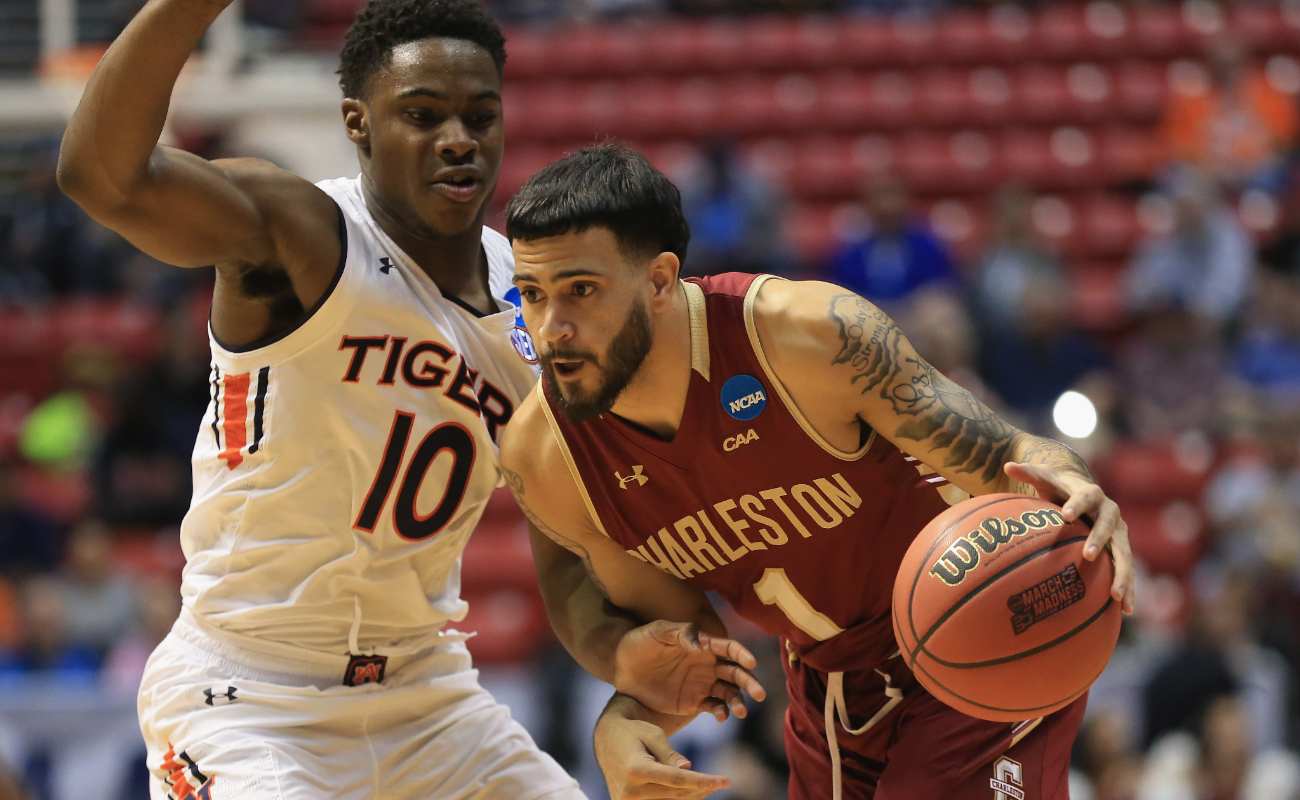 Grant Riller drives against Davion Mitchell. Sean M. Haffey/Getty Images