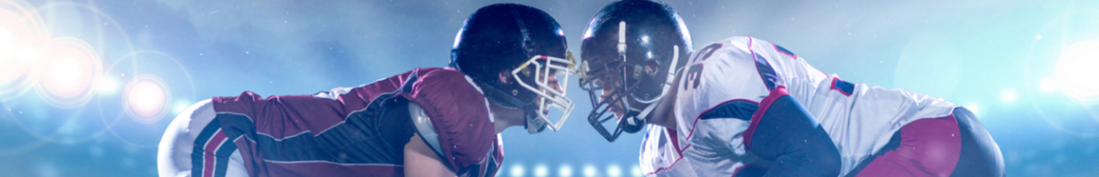two college football players facing each other during night game
