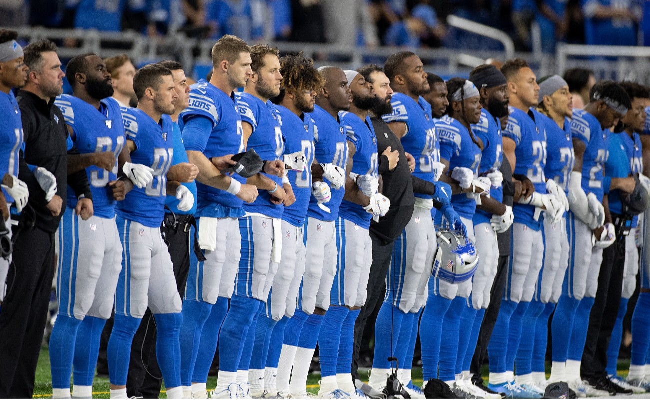 Members of the Detroit Lions line up for the playing of the National Anthem prior to the start of the game against the New York Giants at Ford Field on October 27, 2019 in Detroit, Michigan. Detroit defeated New York 31-26. (Photo by Leon Halip/Getty Images)