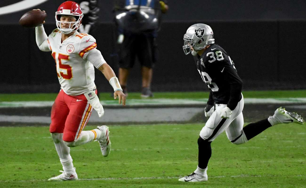Patrick Mahomes Looks to Throw Under Pressure From Strong Safety Jeff Heath. Photo By Ethan Miller