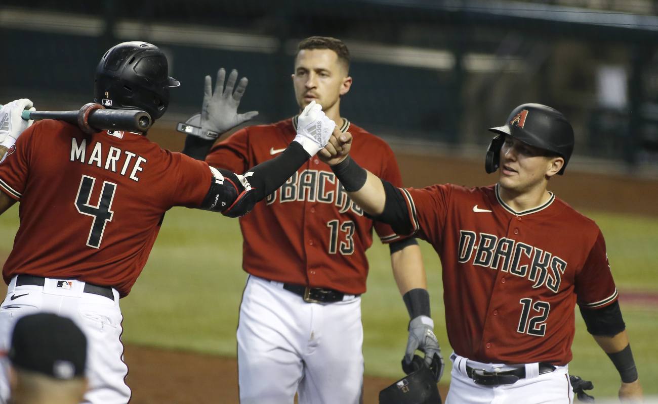 Daulton Varsho 12 and Ketel Marte of the Diamondbacks bump fists. Photo by Ralph Freso/Getty Images