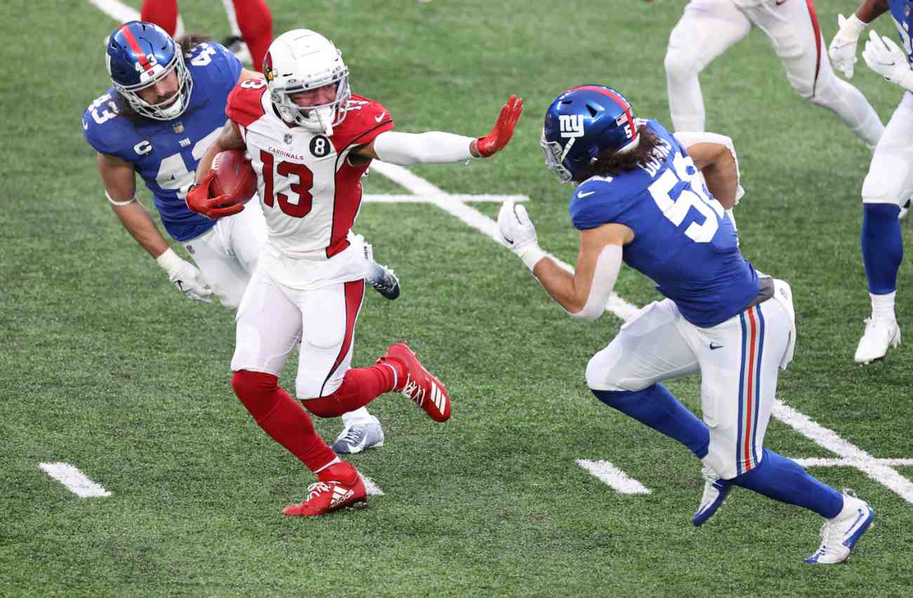 EAST RUTHERFORD, NEW JERSEY - DECEMBER 13: Wide receiver Christian Kirk #13 of the Arizona Cardinals holds out a straight arm as he runs with the ball against linebacker Devante Downs #52 of the New York Giants in the fourth quarter of the game at MetLife Stadium on December 13, 2020 in East Rutherford, New Jersey. (Photo by Al Bello/Getty Images)
