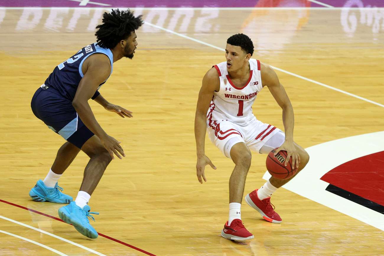 MADISON, WISCONSIN - DECEMBER 09: Jonathan Davis #1 of the Wisconsin Badgers is defended by Malik Martin #12 of the Rhode Island Rams during a game at Kohl Center on December 09, 2020 in Madison, Wisconsin. (Photo by Stacy Revere/Getty Images)