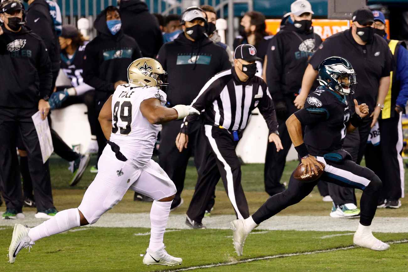 PHILADELPHIA, PENNSYLVANIA - DECEMBER 13: Jalen Hurts #2 of the Philadelphia Eagles rushes the ball past Shy Tuttle #99 of the New Orleans Saints at Lincoln Financial Field on December 13, 2020 in Philadelphia, Pennsylvania. (Photo by Tim Nwachukwu/Getty Images)