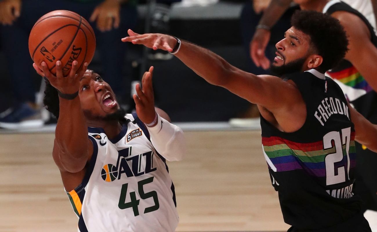 Donovan Mitchell #45 of the Utah Jazz shoots the basketball against Jamal Murray #27 of the Denver Nuggets during game two in the first round of the 2020 NBA Playoffs at AdventHealth Arena at the ESPN Wide World Of Sports Complex on August 19, 2020 in Lake Buena Vista, Florida. (Photo by Kim Klement-Pool/Getty Images)