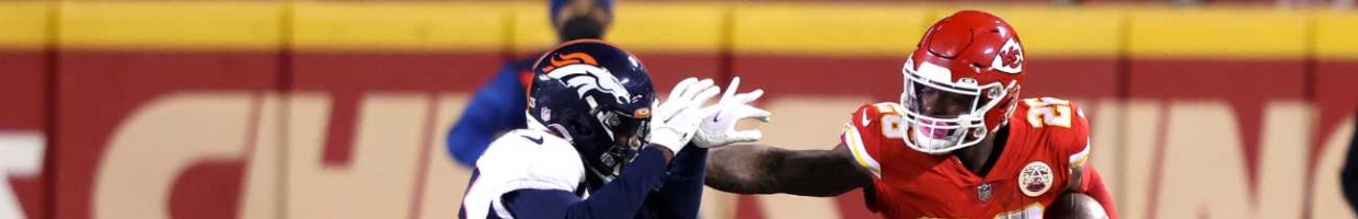 Le'Veon Bell #26 of the Kansas City Chiefs rushes against defender Michael Ojemudia #23 of the Denver Broncos during the first quarter of a game at Arrowhead Stadium on December 06, 2020 in Kansas City, Missouri. (Photo by Jamie Squire/Getty Images)