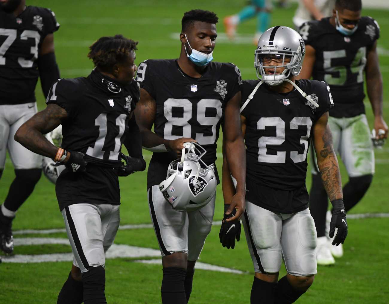 Wide receivers Henry Ruggs III #11 and Bryan Edwards #89 and running back Devontae Booker #23 of the Las Vegas Raiders walk off the field after the team's 26-25 loss to the Miami Dolphins at Allegiant Stadium on December 26, 2020 in Las Vegas, Nevada. (Photo by Ethan Miller/Getty Images)