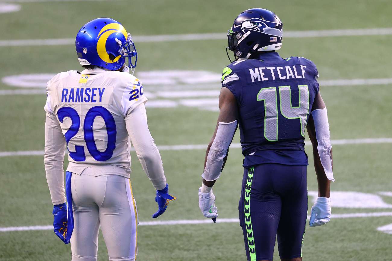 Jalen Ramsey #20 of the Los Angeles Rams and DK Metcalf #14 of the Seattle Seahawks have a conversation in the fourth quarter at Lumen Field on December 27, 2020 in Seattle, Washington. (Photo by Abbie Parr/Getty Images)