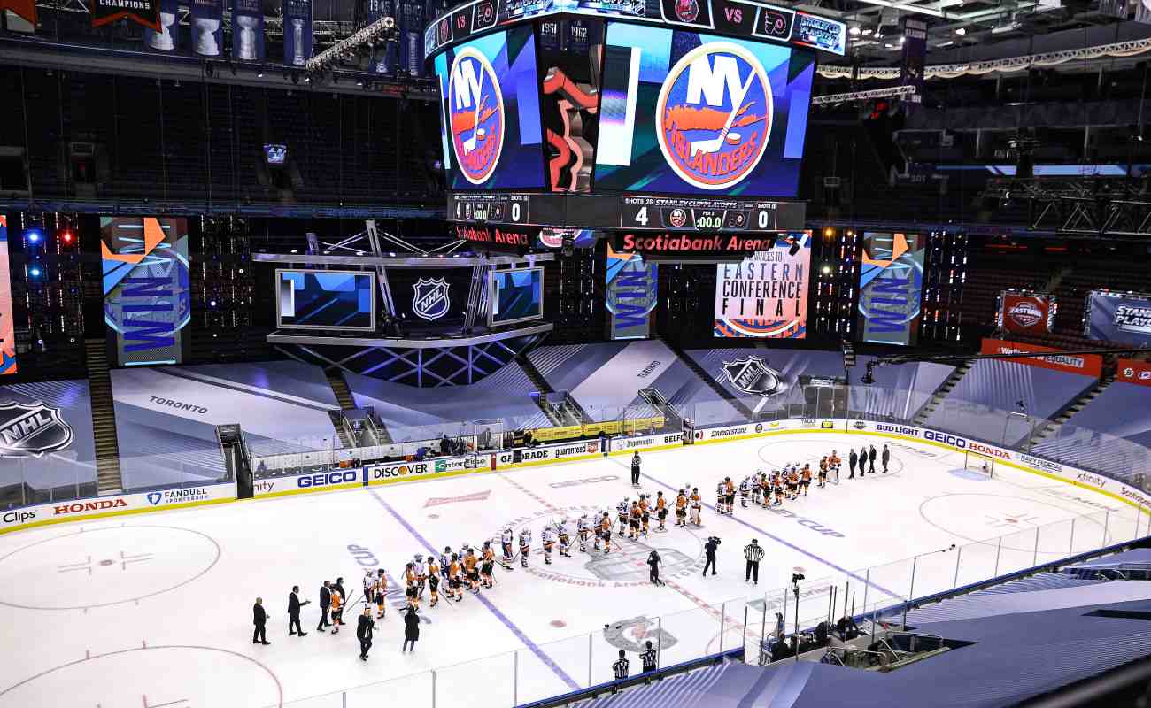 The New York Islanders and the Philadelphia Flyers shake hands before a game at the Scotiabank Arena. Photo by Elsa/Getty Images.