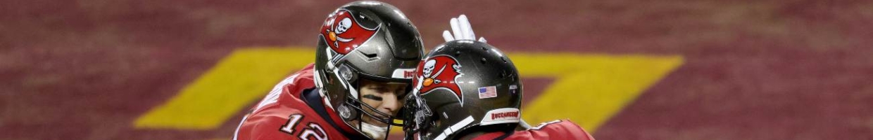 Quarterback Tom Brady #12 and wide receiver Antonio Brown #81 of the Tampa Bay Buccaneers celebrate after connecting for a first half touchdown pass against the Washington Football Team in the NFC Wild Card playoff game at FedExField on January 09, 2021 in Landover, Maryland. (Photo by Rob Carr/Getty Images)