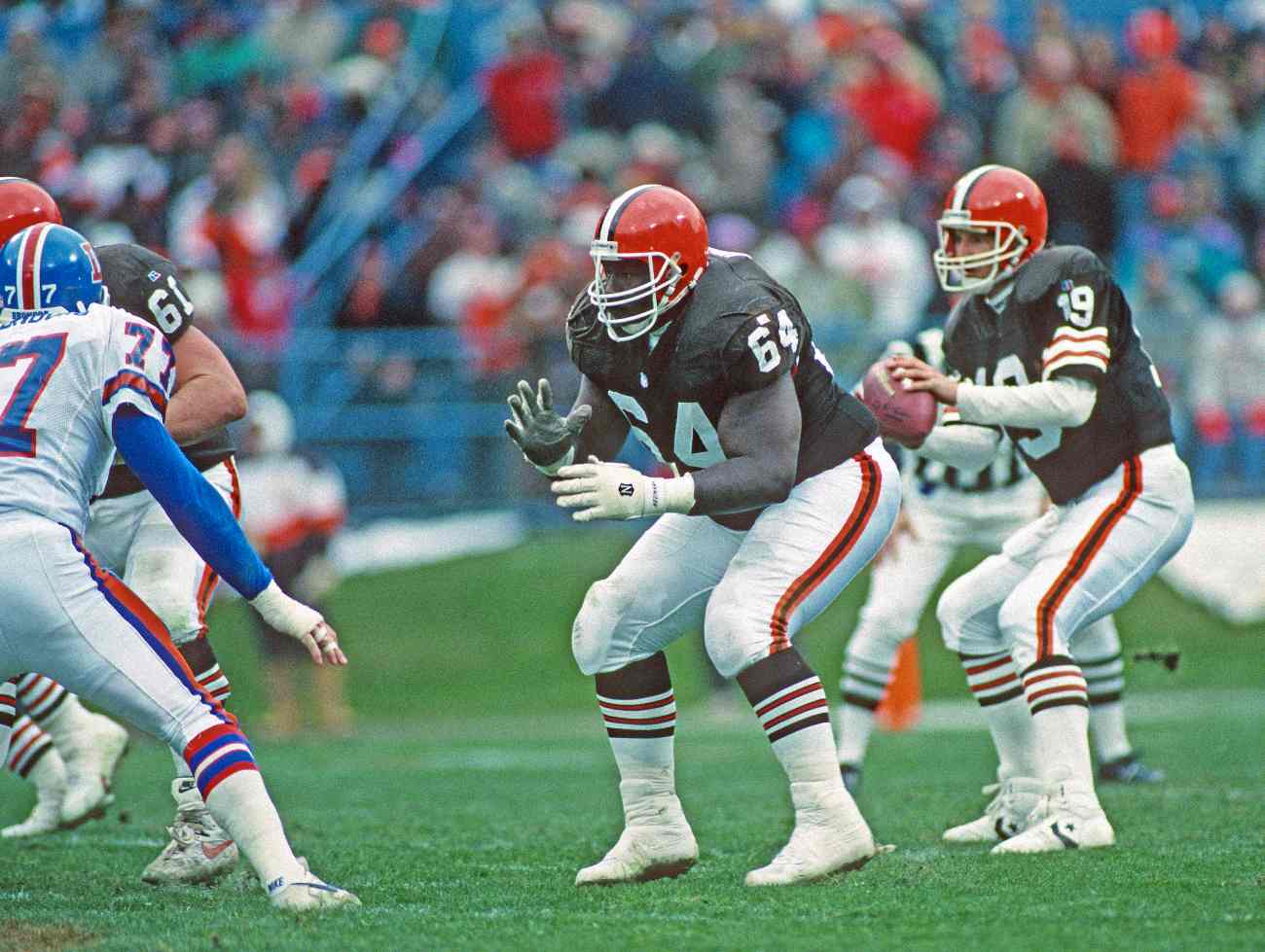 CLEVELAND, OH - NOVEMBER 7: Offensive lineman Houston Hoover #64 of the Cleveland Browns blocks as quarterback Bernie Kosar #19 looks to pass during a game against the Denver Broncos at Cleveland Municipal Stadium on November 7, 1993 in Cleveland, Ohio. The Broncos defeated the Browns 29-14. (Photo by George Gojkovich/Getty Images)