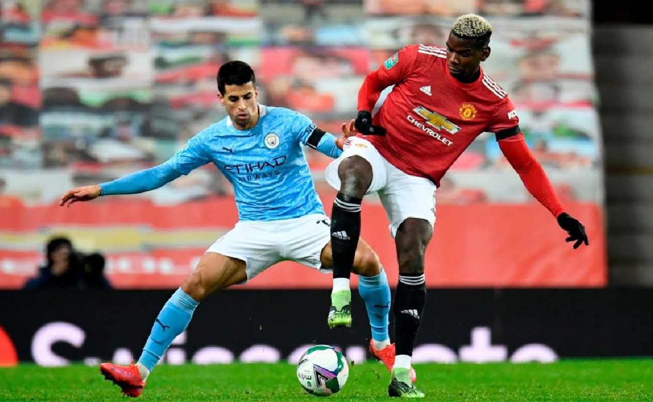 Paul Pogba of Manchester United Battles it Out With Joao Cancelo of Manchester City - Photo by: PETER POWELL/POOL/AFP via Getty Images