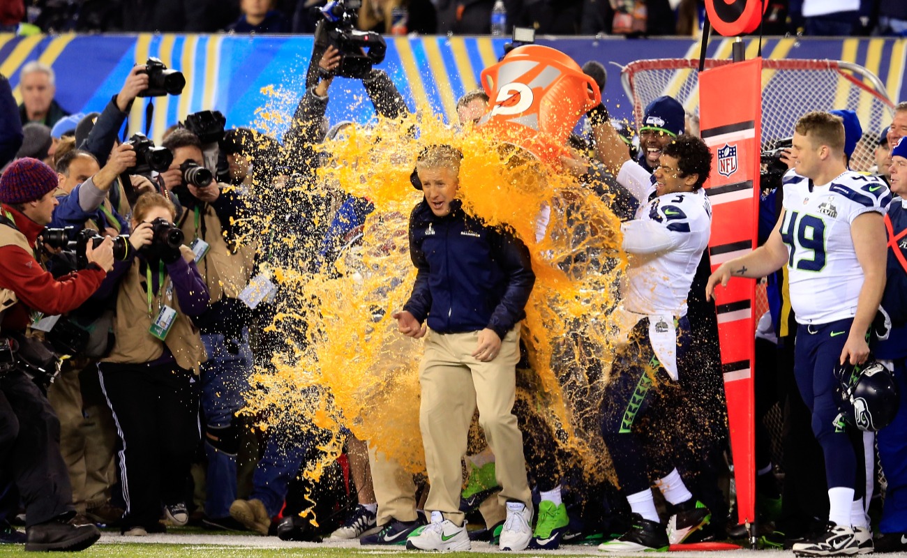 FEBRUARY 02: Tight end Zach Miller #86 and quarterback Russell Wilson #3 of the Seattle Seahawks dump Gatorade on head coach Pete Carroll in the fourth quarter of Super Bowl XLVIII against the Denver Broncos at MetLife Stadium on February 2, 2014 in East Rutherford, New Jersey. The Seattle Seahawks won 43-8. (Photo by Rob Carr/Getty Images)