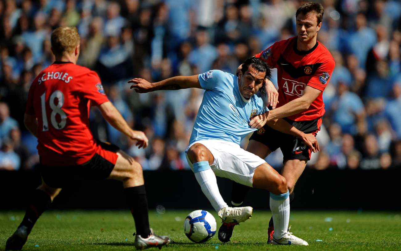MANCHESTER, ENGLAND - APRIL 17: Carlos Tevez of Manchester City battles for the ball with Jonny Evans of Manchester United during the Barclays Premier League match between Manchester City and Manchester United at the City of Manchester Stadium on April 17, 2010, in Manchester, England. (Photo by Laurence Griffiths/Getty Images)