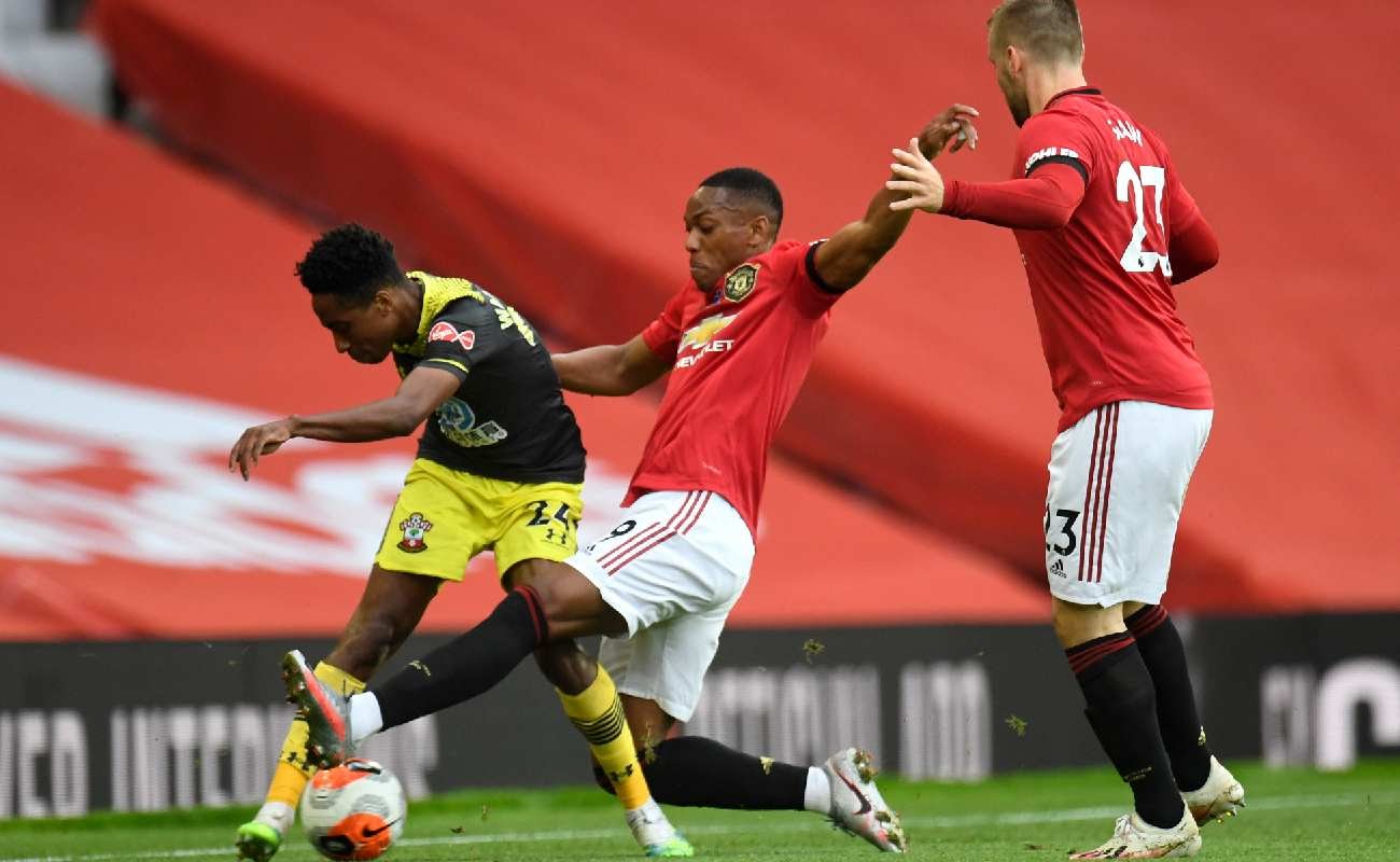Martial and Shaw of Manchester United try get the ball from Southampton’s Walker-Peters - Photo by Peter Powell/Pool via Getty Images