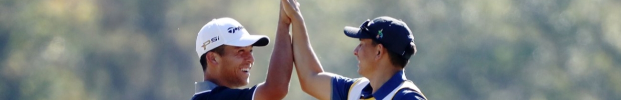 Xander Schauffele celebrates with his caddie after holing in on the second hole during the Final Round of the Sanderson Farms Championship at the Country Club of Jackson on October 30, 2016 in Jackson, Mississippi. (Photo by Sam Greenwood/Getty Images)