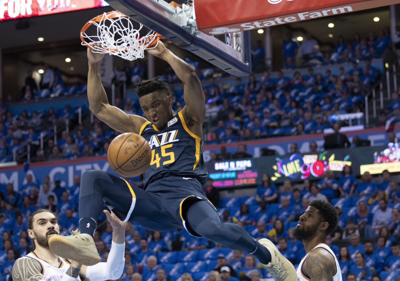 Donovan Mitchell #45 of the Utah Jazz dunks against the Oklahoma City Thunder during the first half of Game 1 of the Western Conference playoffs at the Chesapeake Energy Arena on April 15, 2018 in Oklahoma City, Oklahoma. NOTE TO USER: User expressly acknowledges and agrees that, by downloading and or using this photograph, User is consenting to the terms and conditions of the Getty Images License Agreement. (Photo by J Pat Carter/Getty Images)