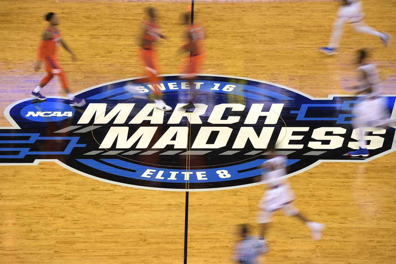 OMAHA, NE - MARCH 23: Players run across the March Madness logo during the game between the Clemson Tigers and the Kansas Jayhawks during the 2018 NCAA Men's Basketball Tournament Midwest Regional at CenturyLink Center on March 23, 2018 in Omaha, Nebraska. (Photo by Lance King/Getty Images)