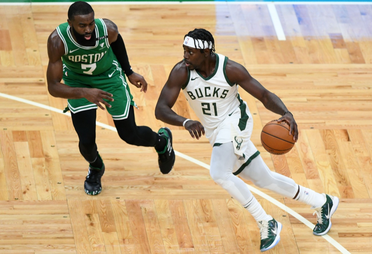 Jrue Holiday #21 of the Milwaukee Bucks dribbles the ball against Jaylen Brown #7 of the Boston Celtics during the first half at TD Garden on December 23, 2020 in Boston, Massachusetts.