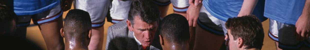 Paul Westhead, head coach for the Loyola Marymount University Lions talks run and gun play system to his players #44 Hank Gathers, #32 Enoch Simmons and #21 Jeff Fryer during the NCAA West Coast Conference college basketball game against the Gonzaga University Bulldogs on 18th February 1989 at the Albert Gersten Pavilion, Los Angeles, California, United States. The Lions won the game 147 - 136 (Photo by Stephen Dunn/Allsport/Getty Images)