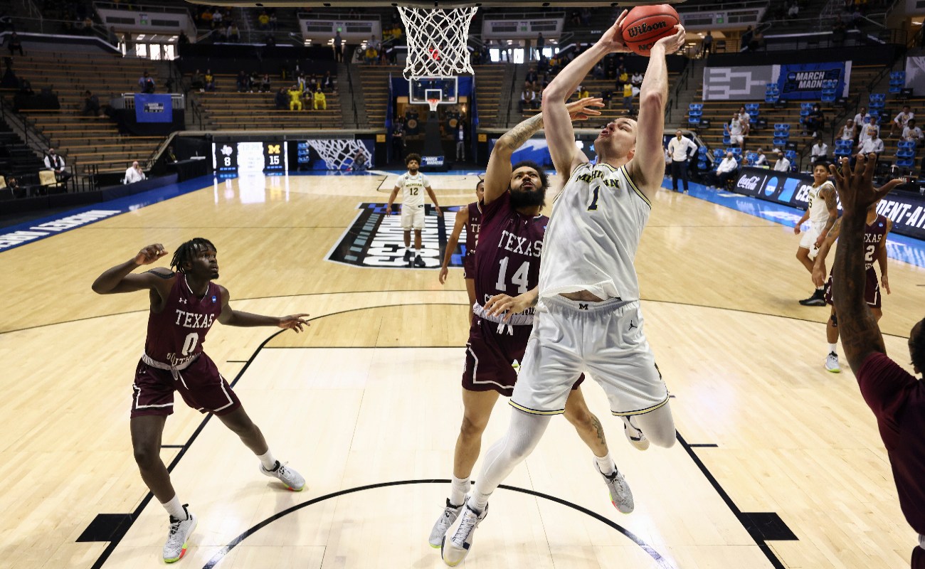 Hunter Dickinson #1 of the Michigan Wolverines shoots against Chris Baldwin #14 of the Texas Southern Tigers during the second half in the first round game of the 2021 NCAA Men's Basketball Tournament at Mackey Arena on March 20, 2021 in West Lafayette, Indiana.