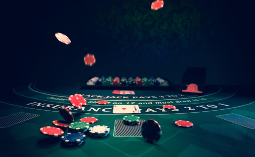 Blackjack table with casino chips and playing cards.