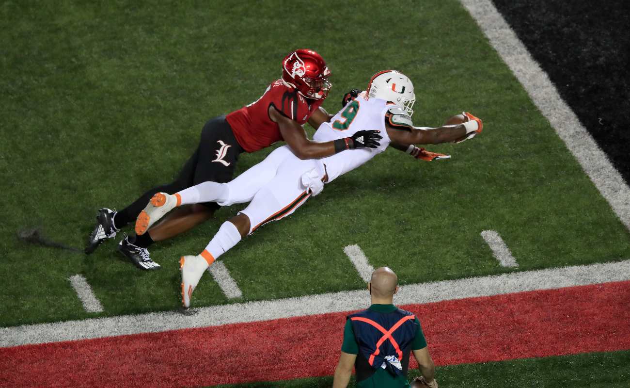 LOUISVILLE, KENTUCKY - SEPTEMBER 19: Brevin Jordan #9 of the Miami Hurricanes dives for the goal line against the Louisville Cardinals at Cardinal Stadium on September 19, 2020 in Louisville, Kentucky. (Photo by Andy Lyons/Getty Images)