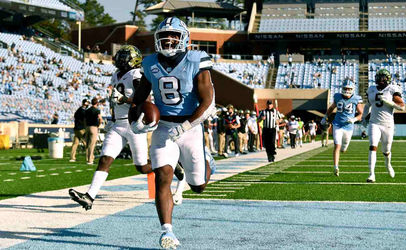 CHAPEL HILL, NORTH CAROLINA - NOVEMBER 14: Michael Carter #8 of the North Carolina Tar Heels scores a touchdown against the Wake Forest Demon Deacons during the fourth quarter of their game at Kenan Stadium on November 14, 2020 in Chapel Hill, North Carolina. The Tar Heels won 59-53. (Photo by Grant Halverson/Getty Images)