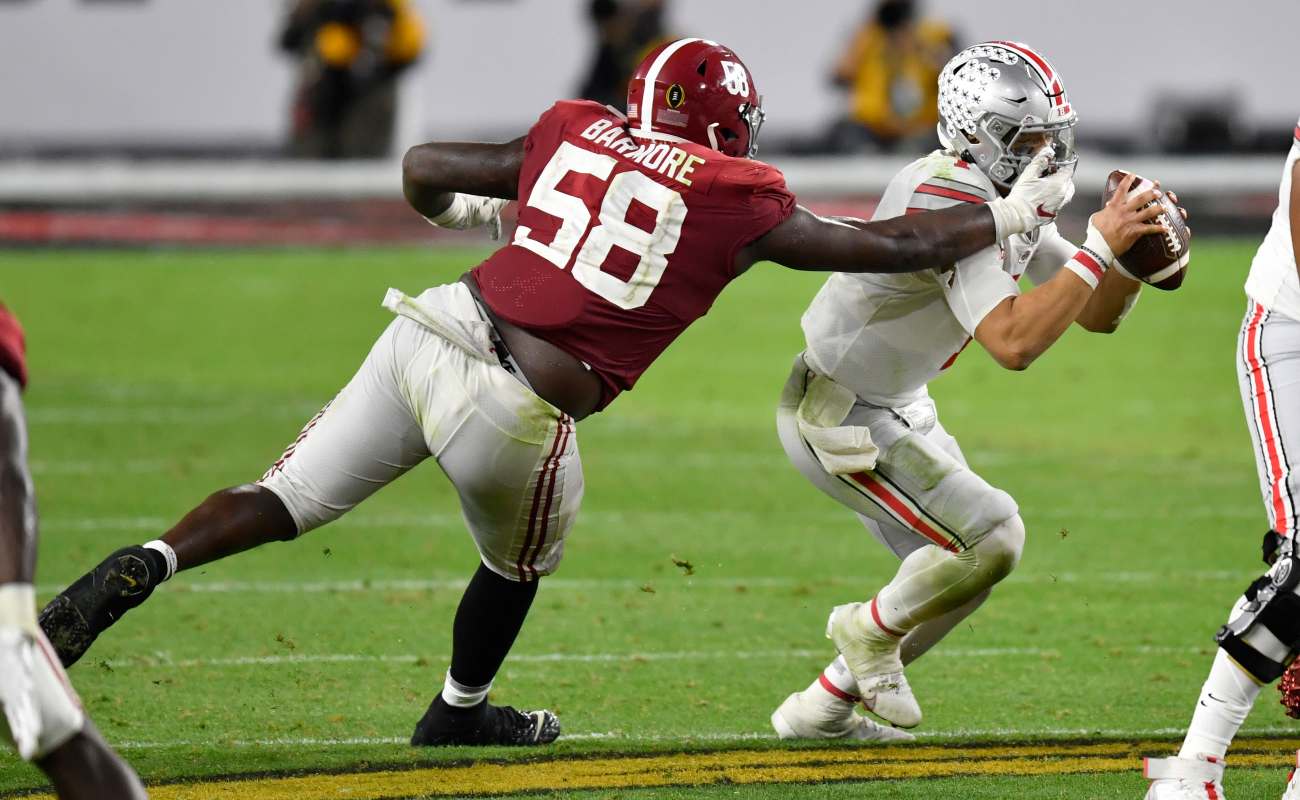 MIAMI GARDENS, FLORIDA - JANUARY 11: Christian Barmore #58 of the Alabama Crimson Tide pressures Justin Fields #1 of the Ohio State Buckeyes during the College Football Playoff National Championship football game at Hard Rock Stadium on January 11, 2021 in Miami Gardens, Florida. The Alabama Crimson Tide defeated the Ohio State Buckeyes 52-24. (Photo by Alika Jenner/Getty Images)