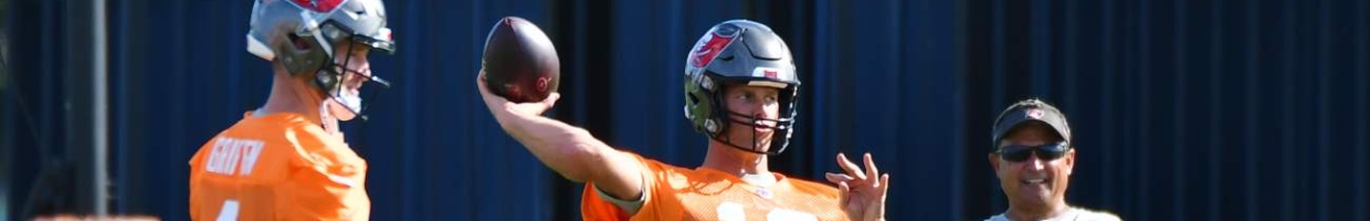 TAMPA, FLORIDA - JUNE 08: Ryan Griffin #4 (L) and quarterback coach Clyde Christensen (R) look on as Tom Brady #12 of the Tampa Bay Buccaneers throws a pass during the Buccaneers Mini-Camp at AdventHealth Training Center on June 08, 2021 in Tampa, Florida. (Photo by Julio Aguilar/Getty Images)