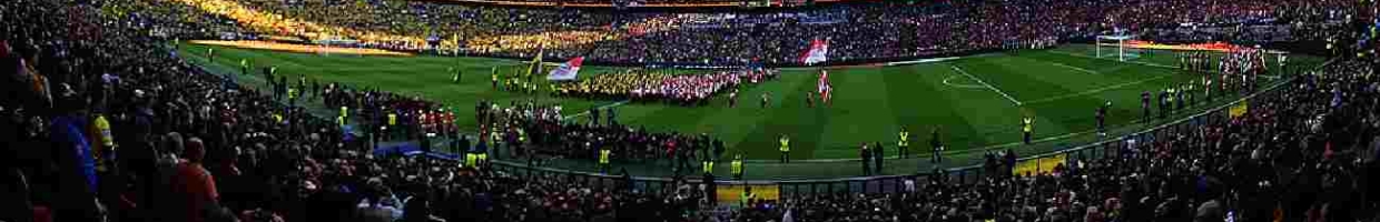 Wembley Stadium with fans and players on the pitch - Photo by Martin Rose/Getty Images