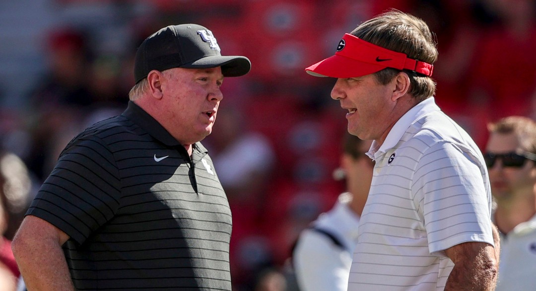 Kentucky head coach Mark Stoops talks with Georgia head coach Kirby Smart before the start of an NCAA college football game Saturday, Oct. 16, 2021 in Athens, Ga. (AP Photo/Butch Dill)