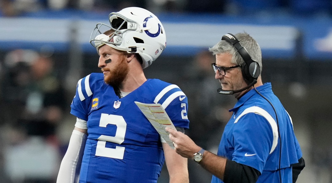 Indianapolis Colts head coach Frank Reich talks with quarterback Carson Wentz (2) during the first half of an NFL football game against the New York Jets, Thursday, Nov. 4, 2021, in Indianapolis. (AP Photo/AJ Mast)